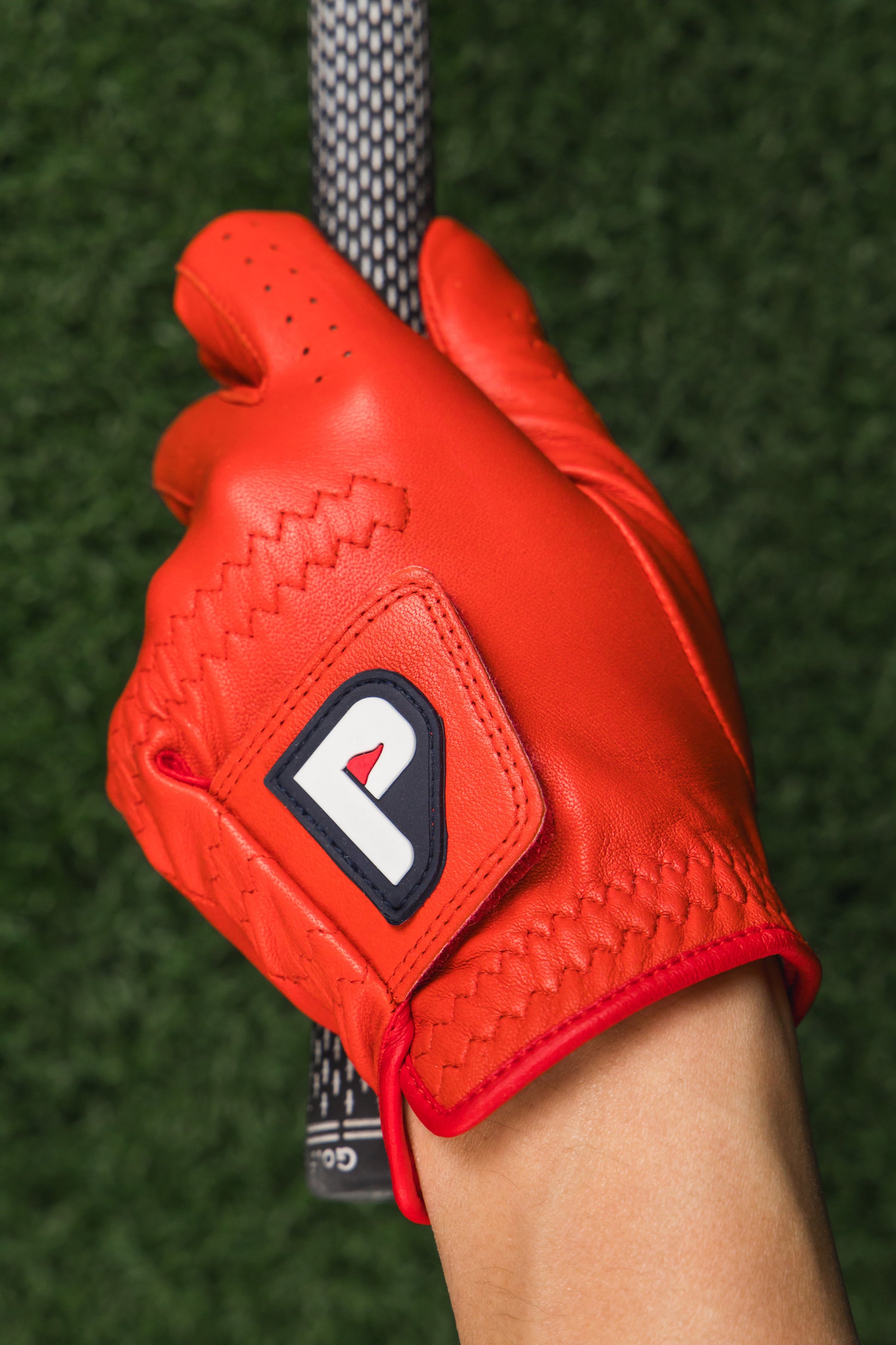 coral-red-Cabretta-Leather-Gloves-while-holding-golf-club
